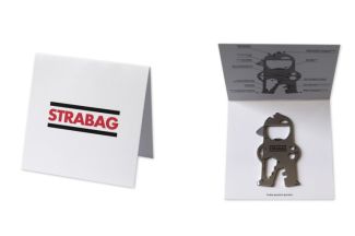 Key tool on white cardboard card with “STRABAG” logo, explanations of the individual tools on the inside