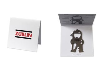 Key tool on white cardboard card with “ZÜBLIN” logo, explanations of the individual tools on the inside
